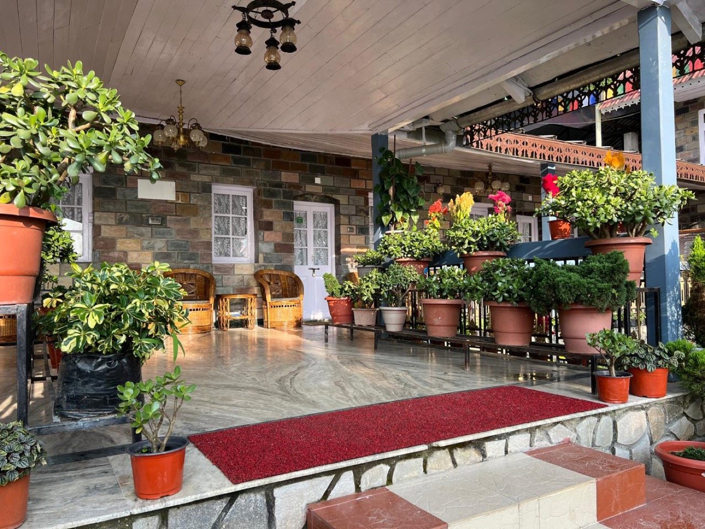 The flower-filled verandah at Saino Heritage Bungalow